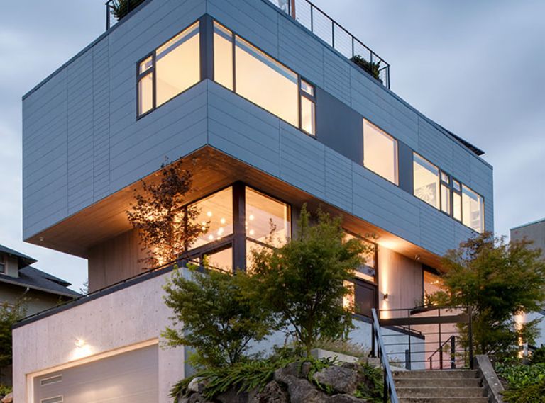 A super-steep, relatively small site brought challenges, but also opportunity. Instead of building out, this home went up to fit just over 3,000 square feet on a city lot. Terraced walkways, patios, and staircases knit the home into the landscape, and the offset cantilevered form creates plenty of opportunities for rooftop outdoor space.