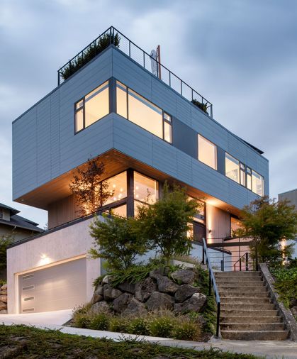 A super-steep, relatively small site brought challenges, but also opportunity. Instead of building out, this home went up to fit just over 3,000 square feet on a city lot. Terraced walkways, patios, and staircases knit the home into the landscape, and the offset cantilevered form creates plenty of opportunities for rooftop outdoor space.