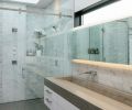 The master bathroom shower is lined in Carrera marble and tiled with porcelain. The sink is a single piece of cast concrete.