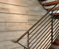 A board form concrete wall adds texture and visual interest to the stairwell.