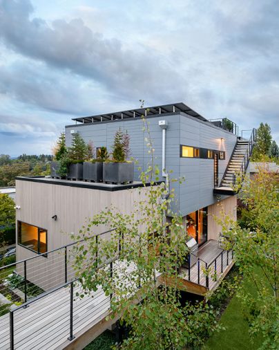 Rooftop planters are filled with dwarf conifers that evoke an alpine forest.