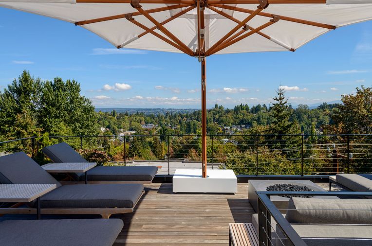 The rooftop patio features a built-in firepit and views of the Cascades and Puget Sound.