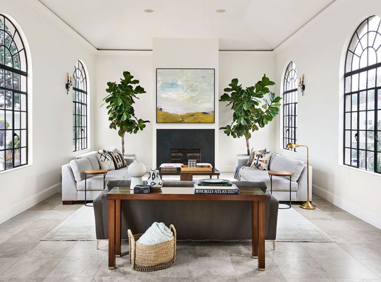 The original arched steel windows and sconces remain intact in the vaulted ceiling living room with expansive city views and 5,558 sq. ft. of terraces. Custom cold rolled steel firebox pops amidst a newly designed and constructed chimney.