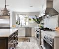 Custom Vent-A-Hood range hood crowns Wolf cooktop. Rohl sink and water faucet. Single Danby marble slab island countertops fabricated by de la tierra, inc. Cabinets are outfitted with drawer pulls from Chown Hardware.