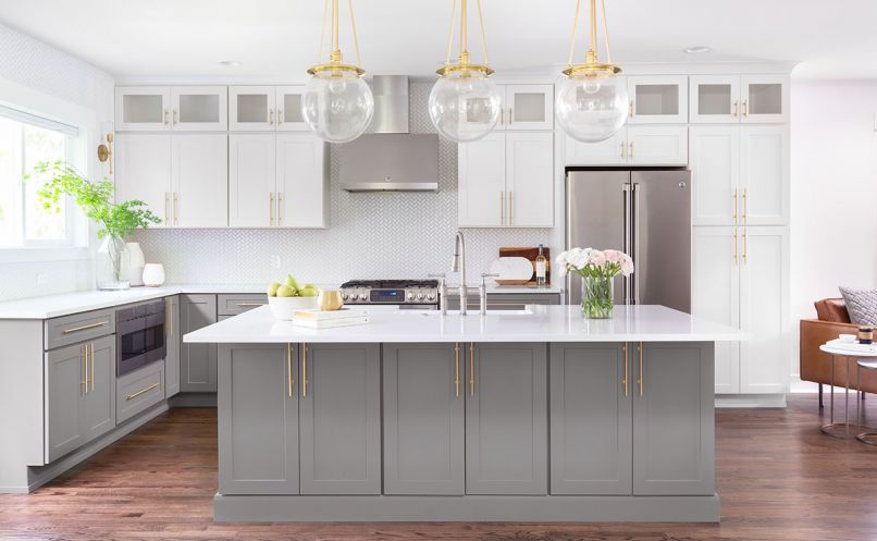 CABINETRY A standout in the mostly white kitchen, the mid-tone gray hue from Benjamin Moore on the cabinets is augmented by the gold in the hardware. COUNTERS + LIGHTING White Space chose Pental Quartz countertops with a subtle, yet warm veining to add interest but keep the kitchen’s clean, uncluttered aesthetic.