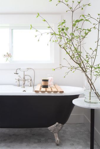 In the master bath, Justine Lyon’s “sanctuary,” a vintage-style black tub with opulent silver feet sits upon carrara marble flooring done in a small hex pattern, which continues in a larger format in the freestanding shower.
