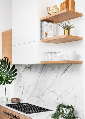 The same Carrera marble used for the countertops was also employed as a backsplash behind the Wolf range.