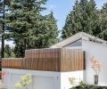 To screen the deck from neighboring homes, Treebird Construction installed a vertical slatted screen from cedar boards that would create privacy while still letting in plenty of light.