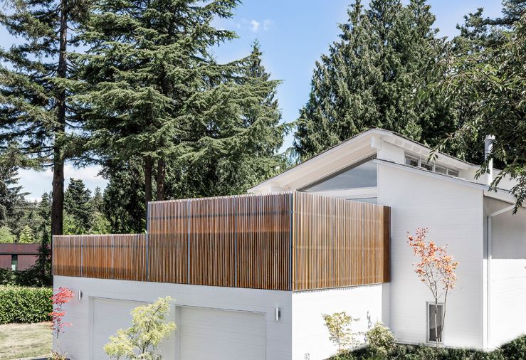 To screen the deck from neighboring homes, Treebird Construction installed a vertical slatted screen from cedar boards that would create privacy while still letting in plenty of light.