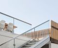 Steel stringer stairs with a cantilevered glass guardrail and precast concrete treads provide access to the deck while preserving the view.