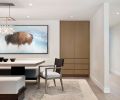 In the dining room, focal point artwork by Aaron Hexom depicting a buffalo—an animal that has special significance to the family—adds an ethereal quality, and a crystal droplet light from Bone Simple is a decorative touch. Rug from Stacey Logan.