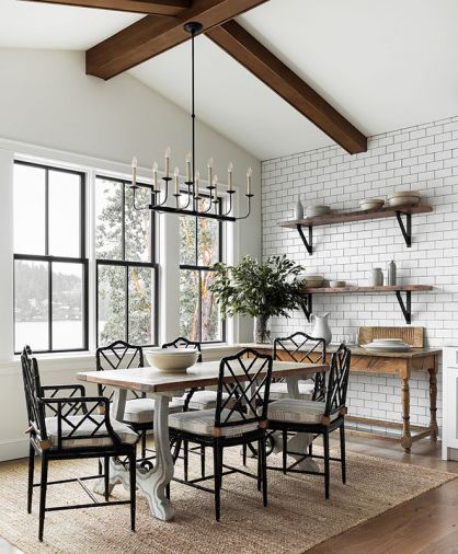 Open shelving in the dining room is designed as a venue to display items from the client’s collection, and is backed by a feature subway-tiled that continues through to the kitchen. A new mudroom done in white shiplap serves as a connection between the added carriage house and garage and features the white oak flooring found throughout the home. Windows by Sierra Pacific.