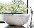 A marble Papillon Stone Forest bathtub with Brizo Virage Tub Filler adds soft lines to master bath.