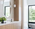 Master Bath dual vanity lit by Atelier de Troupe pendants. Oval mirrors pop against Island Stone “Profiles” “cladding” wall tile. Vanity countertops feature Lapitec matte finish Polare Satin, a sintered stone slab impervious to weather and resistant to stains.