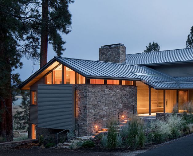Architect Miles Woofter aimed to both take advantage of and update the home’s existing cruciform plan, including adding windows to improve daylight. The four main quadrants allow for connectivity between the sloping site’s trees and Cascade Mountain views, as previously there was no way to circulate around the property. The remodel also added a new 30-by-30-foot covered exterior entry plaza. Set between two rock sculpture garden areas, it is paved in large-format sandstone tiles that continue into a glass-and-cedar-clad vestibule. 