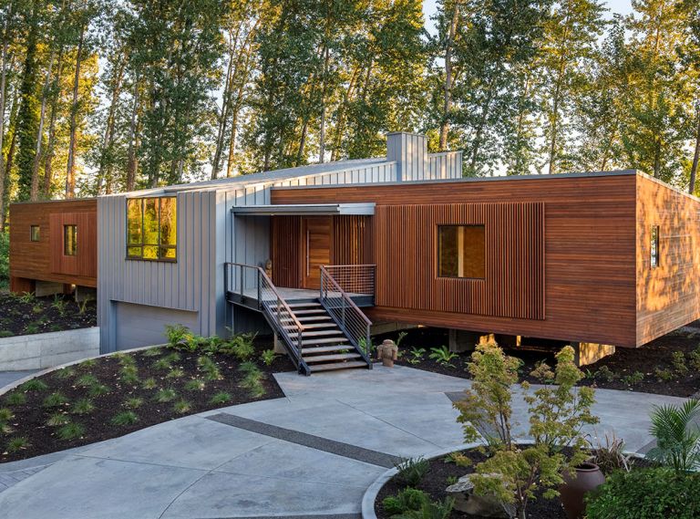 Spaced vertical mahogany boards create a screen framing metal clad wood Sierra Pacific windows.