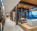 Exposed steel columns draw the eye to Steve Jensen’s wood carving “Tangled Lines.” Insulated oak ceiling adds visual warmth while trapping sound. Weiland glass doors and clerestory windows open onto spectacular views. Quarter sawn rift white oak flooring meets porcelain tile entry. Photo © Derek Reeves