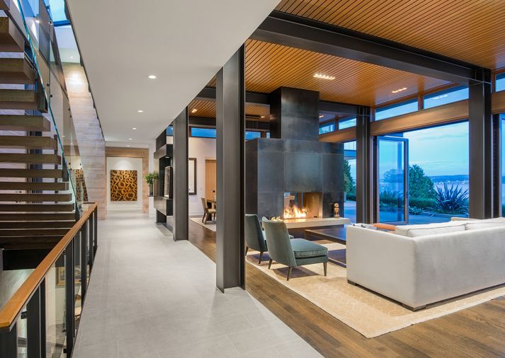 Exposed steel columns draw the eye to Steve Jensen’s wood carving “Tangled Lines.” Insulated oak ceiling adds visual warmth while trapping sound. Weiland glass doors and clerestory windows open onto spectacular views. Quarter sawn rift white oak flooring meets porcelain tile entry. Photo © Derek Reeves