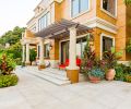 The French limestone terrace acts as a wonderful foil for the joyful color display. Accenting the limestone and architecture, fine Italian Impruneta terra cotta containers are placed throughout the landscape.