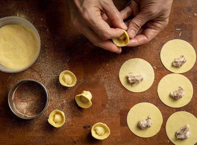 McKee forms Cappelletti pasta (little hats) by hand.