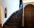 Restored original architectural elements include arched entry closet, curved staircase and niche.