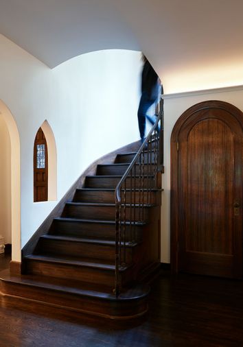 Restored original architectural elements include arched entry closet, curved staircase and niche.