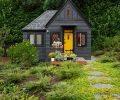 Former child’s playhouse turned guest house with vaulted ceilings to add volume to space. Sherwin Williams Auric painted door pops against Greenblack body and Caviar trim. Alchemie Landscaping.