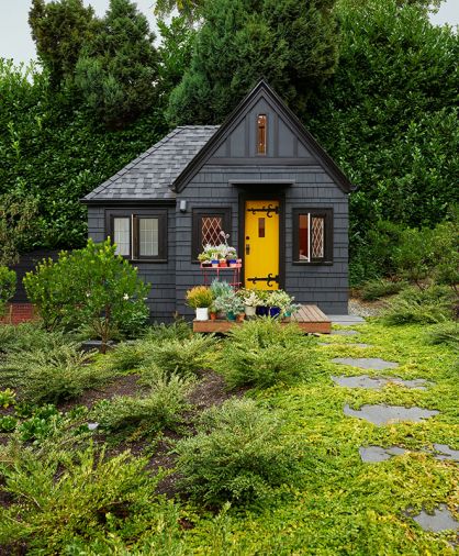 Former child’s playhouse turned guest house with vaulted ceilings to add volume to space. Sherwin Williams Auric painted door pops against Greenblack body and Caviar trim. Alchemie Landscaping.