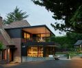 An existing flat roof dormer was expanded to accommodate the new addition. Salvaged demolition brick pairs with black painted Aluminum plate siding to transition from old to new.