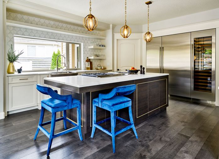 By replacing the original 2' kitchen window with a 7.5' horizontal Milgard window above the sink, light now pours into the once dark, cherry wood interiors. A custom island by Hayes Cabinets mimics the new, modern fireplace wall’s built-in’s rift cut oak stained dark matte black.