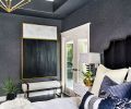 Original glass French doors lead into the master bathroom at right. Hertner replaced the shower’s wing wall with a glass walk-in shower. An upscale California closet lies beyond. Bernhardt Interiors bench grounds modern graphic art reiterating color theme.