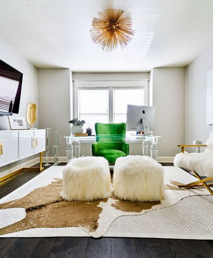 An upstairs sitting room gets a classy upgrade to a sleek woman’s office with plenty of sparkling glass furnishings, including a Modshop desk, candlesticks and side table. The brilliant white World’s Away console with brass base and hardware strikes a high note.