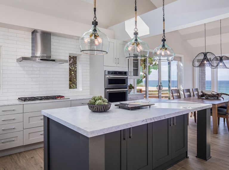 Paramount for the kitchen of this Gleneden Beach retreat was to merge the indoors and out, and to lighten a once dark, cavelike feel. “The challenges were to create a large open space and maintain the structural integrity of the loft above,” says C&R Design Remodel co-owner Beth Rhoades. “This required beams over the kitchen’s new location. We also needed to address the cooktop ventilation. The end result was to sheetrock those to have them disappear in the space.”