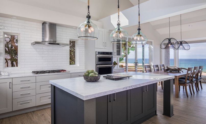 Paramount for the kitchen of this Gleneden Beach retreat was to merge the indoors and out, and to lighten a once dark, cavelike feel. “The challenges were to create a large open space and maintain the structural integrity of the loft above,” says C&R Design Remodel co-owner Beth Rhoades. “This required beams over the kitchen’s new location. We also needed to address the cooktop ventilation. The end result was to sheetrock those to have them disappear in the space.”