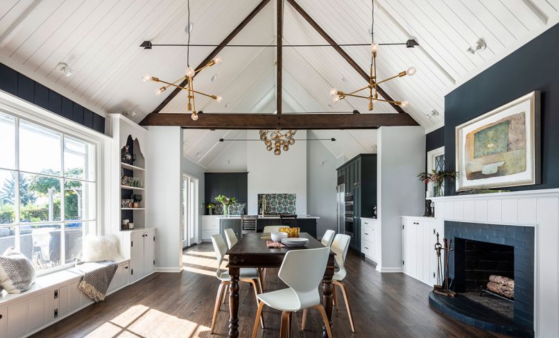 A typical 1940s interior—think lots of small, defined spaces separated by doorways and walls—made the kitchen and dining areas feel cramped. By removing interior walls and raising the ceiling to the roofline, this project transformed a historic home into a light, bright, airy space. Yet by keeping the original built-ins and echoing traditional design elements like crown molding and lapboard in other areas of the home, the remodel stayed true to the underlying structure.
