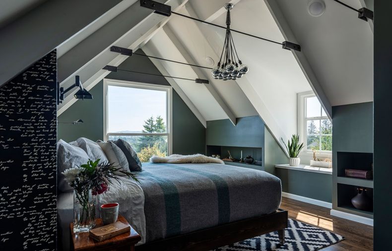 In the master bedroom, wall-mounted lamps on each side of the bed provide light for reading without taking up valuable bedside table real estate. In rooms with steeply sloping ceilings, built-in shelving along the low edges turns space that might be wasted into valuable storage.