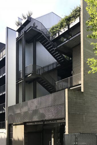 The building’s exterior underwent clean up, new paint, added mechanical and storage space, enlarged terrace; clients added planters for additional greenery.