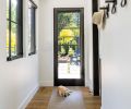 Metal clad Loewen windows have wooden interiors, painted black. Portella door opens to back patio, Paloform Bol adds pop of color and contrast. Golden locust tree adds halo of gold to Treherne’s landscape design