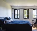 Upstairs daughter’s bedroom features Room&Board Parson’ bed in natural steel tied to slim-lined black pendants from Seattle Lighting.