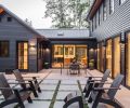 Back patio trimmed in Herniaria glabra toward kitchen. Tongue and groove cedar trim on eaves adds interest to dark siding and metal clad Loewen windows.