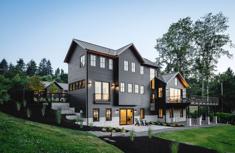 Three-story 3,625 sq. ft. contemporary farmhouse oriented toward harbor view. Artist workshop at right, daylight basement below.