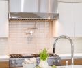 Eye-catching range 1x6 backsplash by Dal Tile Color Wave in Feather White.