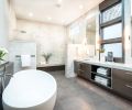 Dual sink vanity with quartzite countertops from Pental. Stacked windows framed in Metallic subway tile that echo fireplace surround in master bedroom. Tech Lighting sconces with brushed nickel cuff on mirrored wall.