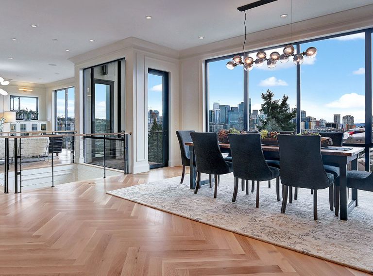 By reverse-positioning the living and dining areas upstairs on the top floor, Rogers and Hale give homeowners the opportunity to fully enjoy the spectacular views of downtown Seattle’s iconic Space Needle. A pair of Fleetwood doors open onto a balcony tucked between the two main rooms, while a floor-to-ceiling Fleetwood window provides a view downward into the first-floor entry foyer. The U-shaped central staircase with capped skylight rises directly behind it, opening onto the view.