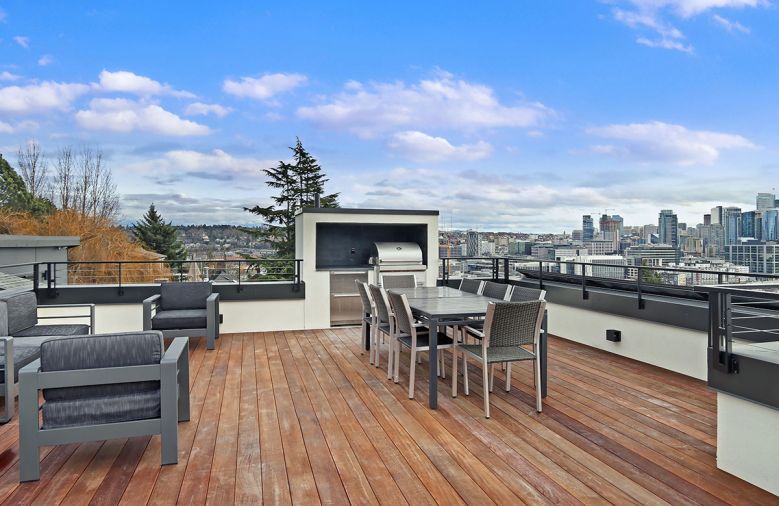 Hard Ipe wood rooftop decking, linear fireplace. Capped skylight right.