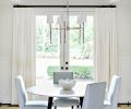 A high ceiling and French doors help fill the refreshed dining room with light.