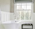 A claw-foot tub and zebra stool bring old world elegance to a first floor full bath.