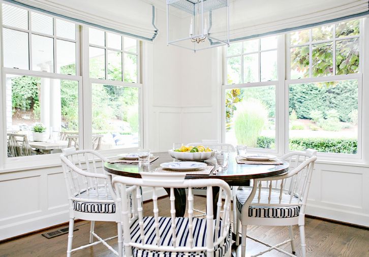 Informal family meals can be enjoyed at the table in the kitchen. White walls, chairs and light fixture help bring airiness to the room’s corner while the wood table keep it grounded. Outside are a patio dining area and vegetable garden also created by Trove.