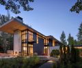 The steel-and-wood-clad Stirrup House features Fleetwood Kona Windows beneath a steel roof system that flexes beneath weighty snow. Glass-box master suite right occupies the secondary portion of “T” shape architecture. 
Photography ©Aaron Leitz