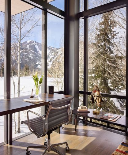 DeGennaro’s office overlooks a snowy landscape framed by structural steel and glass by Fleetwood Windows. African mask is a memento from DeGennaro’s African trip.